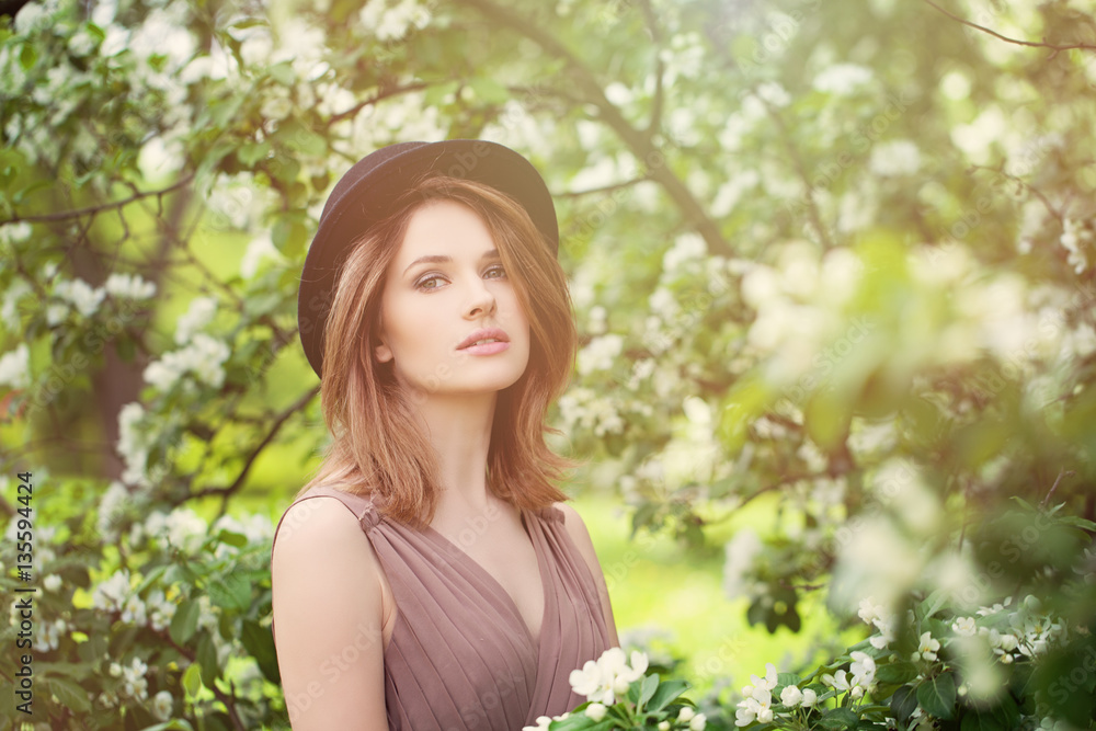 Young Beauty in Spring Sunlight. Healthy Woman on Bloosom Backgr Young Beauty in Spring Sunlight. Healthy Woman on Bloosom Backgr