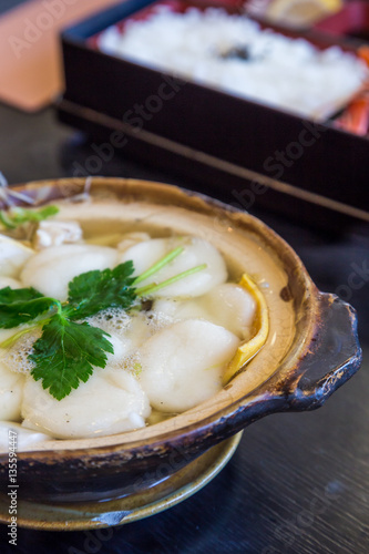 Traditional Shimabara Guzoni - soup with rice cake and seafood photo