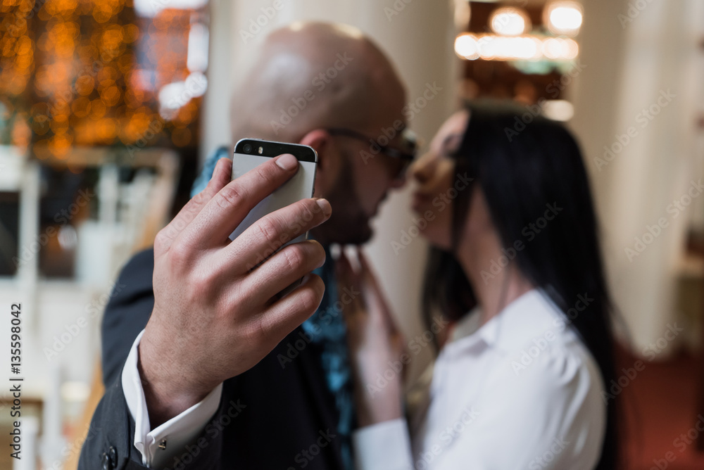 Arab businessman and girl making selfie in the shopping center