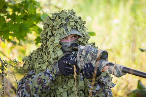 a military man in an ambush in the forest photo