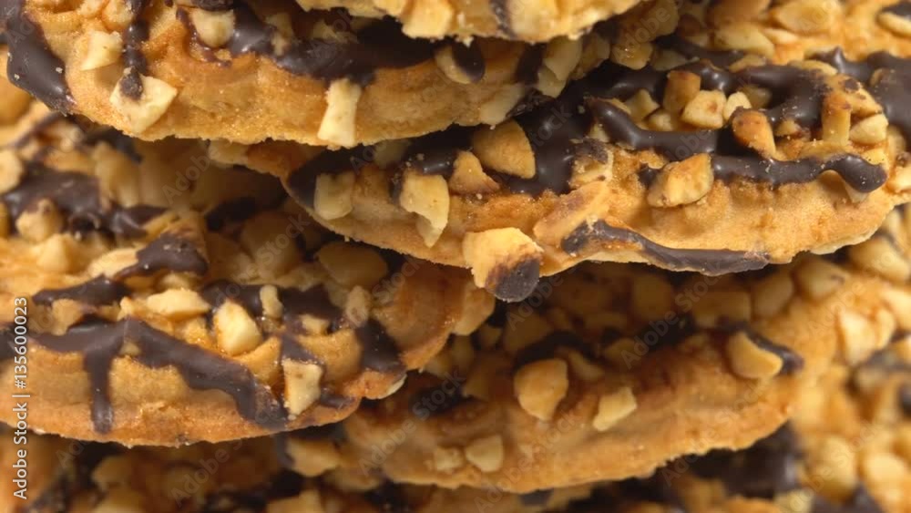 Cookies with nuts and chocolate rotates on a white table 4K Cookies with nuts and chocolate rotates on a white table 4K