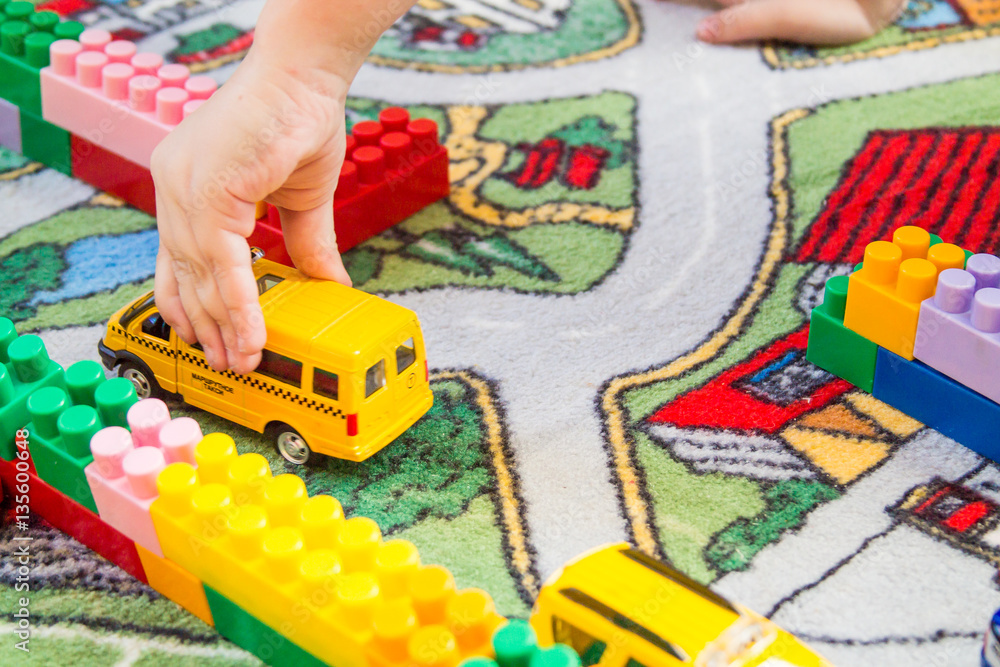 Fototapeta premium boy playing toy cars