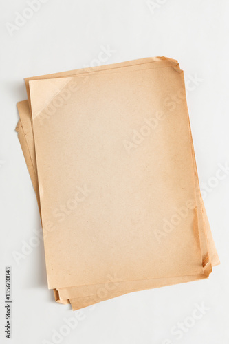 old craft paper sheets pile isolated on white background