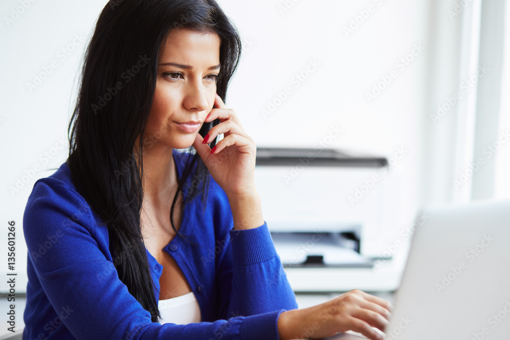 Pensive woman sitting in the home office Pensive woman sitting in the home office