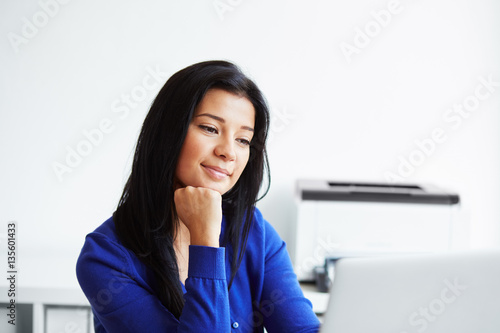 Woman working with laptop in the home office