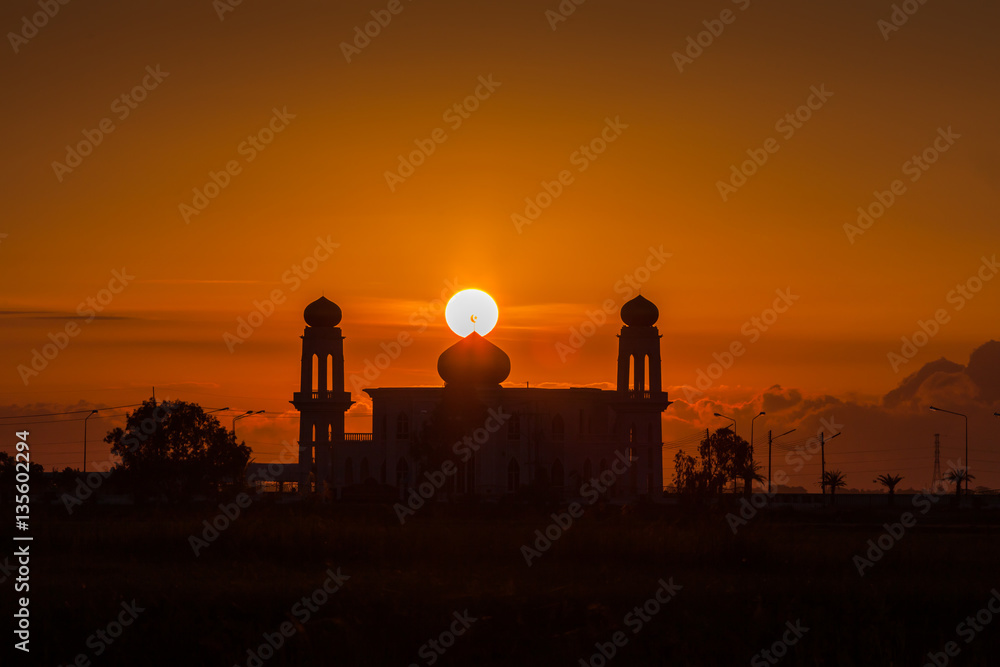 A silhouette of a mosque at sunrise vivid color , Thailand A silhouette of a mosque at sunrise vivid color , Thailand