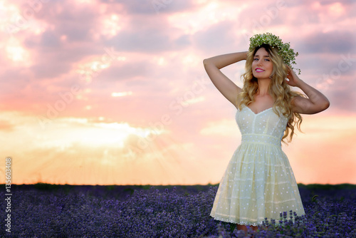 Beautiful Girl in lavender Field at sunset. Pretty woman Provence style in a dress and flowers wreath. Beautiful blonde woman in the lavender field on sunset Amazing portrait © castecodesign