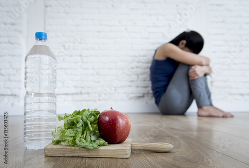 Quadro su tela woman or teenager girl sitting on ground alone worried at home suffering nutrit
