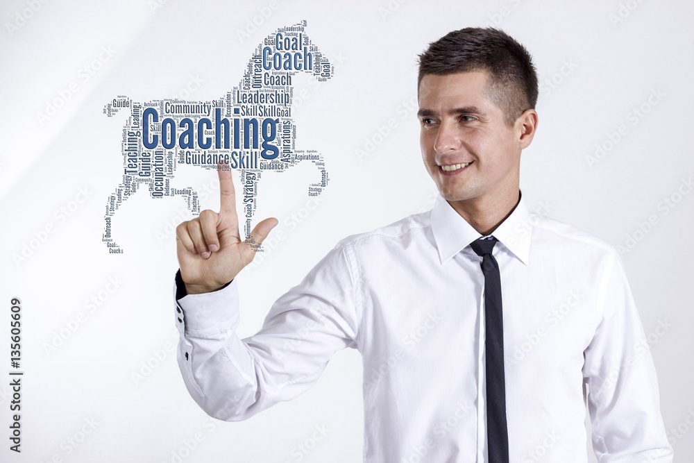 Coaching - Young businessman touching word cloud Coaching - Young businessman touching word cloud