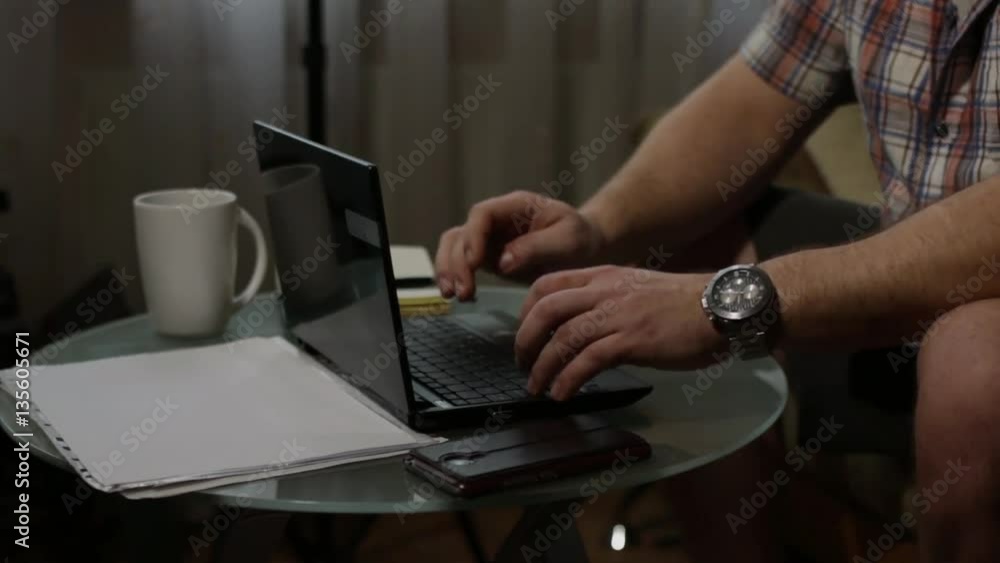 Man typing at home desk Man typing at home desk