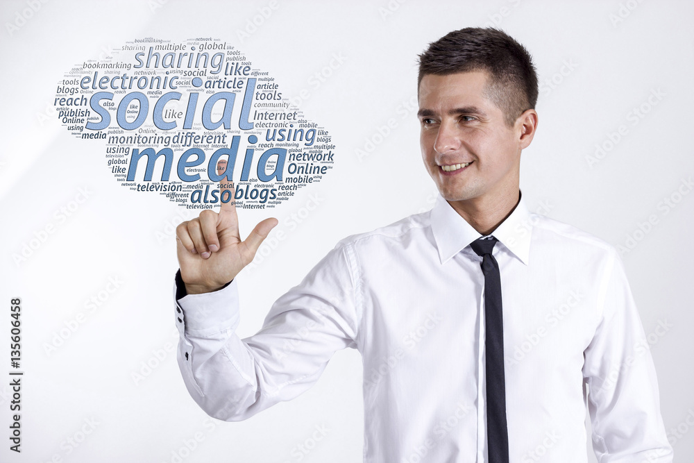 Social media - Young businessman touching word cloud Social media - Young businessman touching word cloud