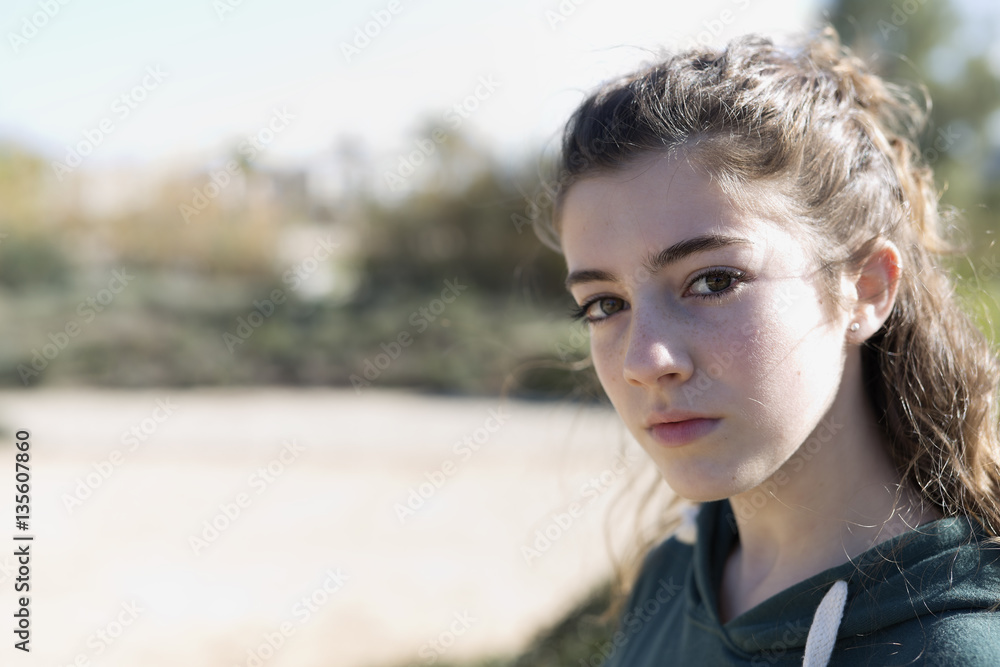Portrait of a young girl in a park. Portrait of a young girl in a park.