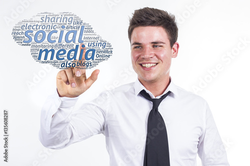 Social media - Young businessman touching word cloud