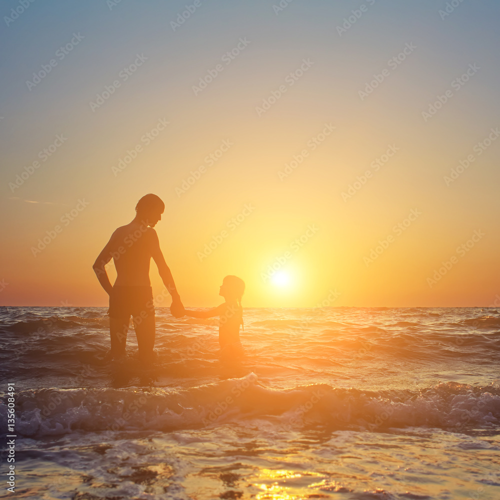 father and daughter at sunset