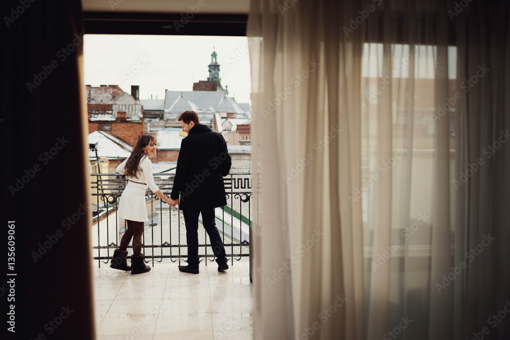 beautiful and young couple standing together on terrace beautiful and young couple standing together on terrace