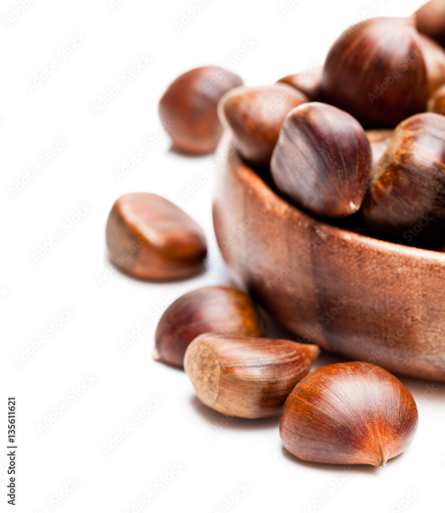 sweet chestnut in wooden plate isolated on white background sweet chestnut in wooden plate isolated on white background
