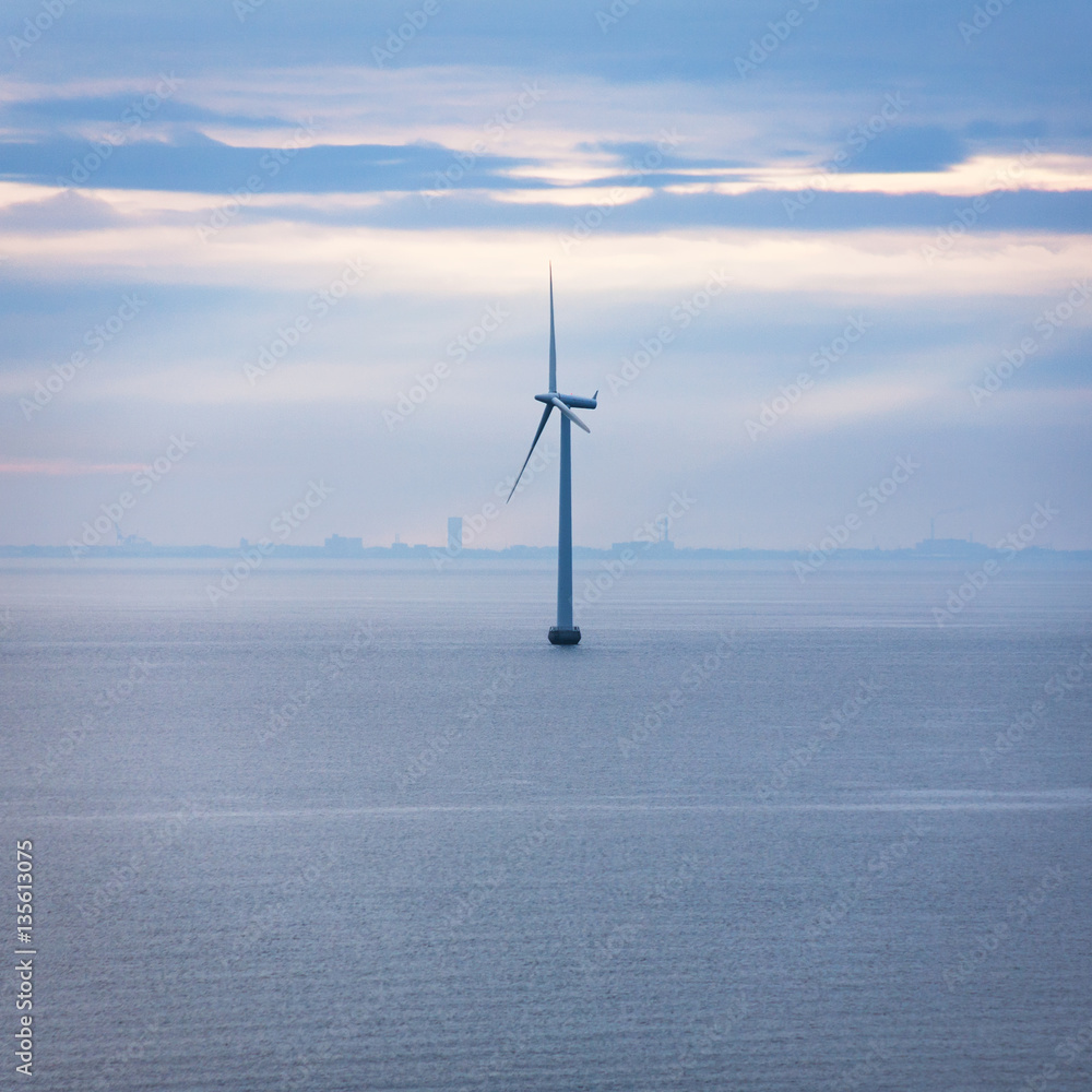 one turbine of offshore wind farm in morning