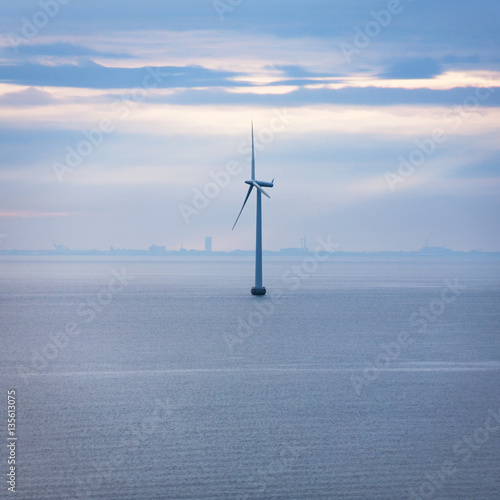 one turbine of offshore wind farm in morning