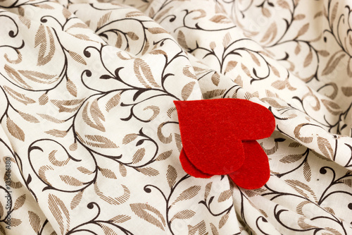 Small red heart from felt on linen