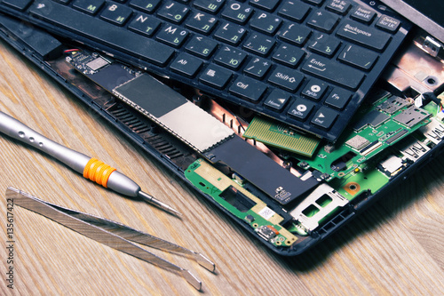 Screwdrivers and disassembled computer