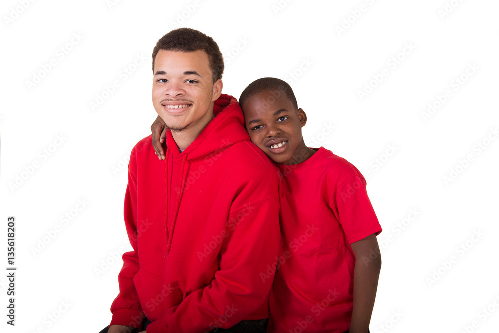 A school aged boy and his older teenage brother isolated on white A school aged boy and his older teenage brother isolated on white
