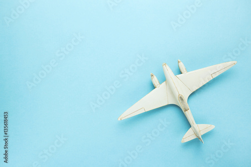 Miniature toy airplane on blue background