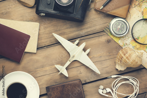 Outfit of traveler with accessories on wooden background