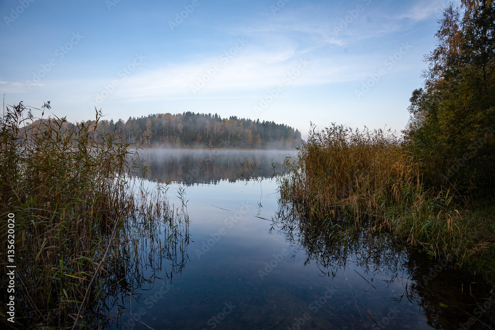 misty countryside landscape with lake in latvia