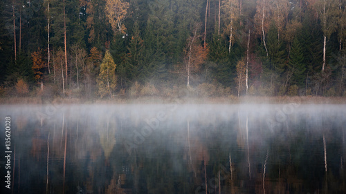 misty countryside landscape with lake in latvia