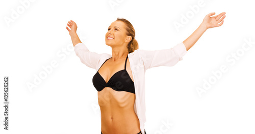 Attractive millennial woman standing in front of white background feeling wind © rocketclips
