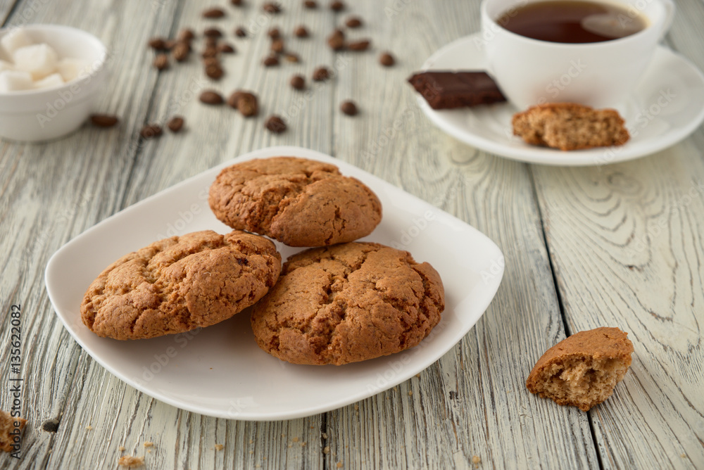 Homemade oat cookies with coffee on a wooden background Homemade oat cookies with coffee on a wooden background