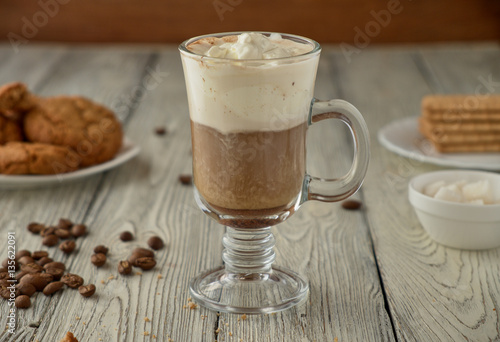 Viennese coffee with oat cookies on a wooden background