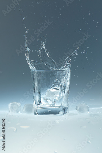 ice cube falls in a glass of water
