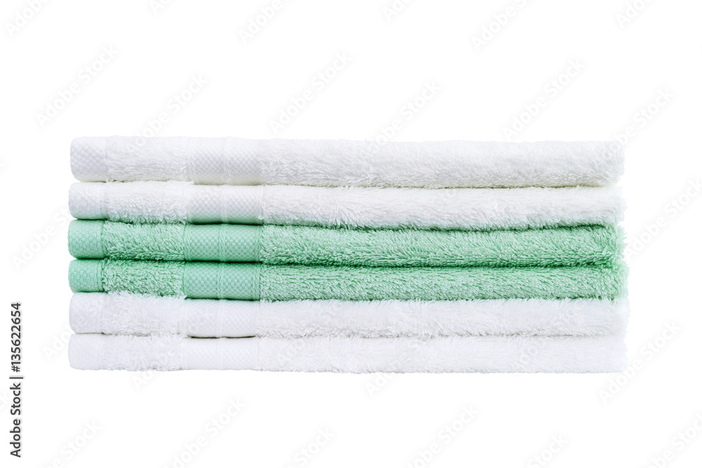 Stack of white and green bath towels isolated over white background Stack of white and green bath towels isolated over white background