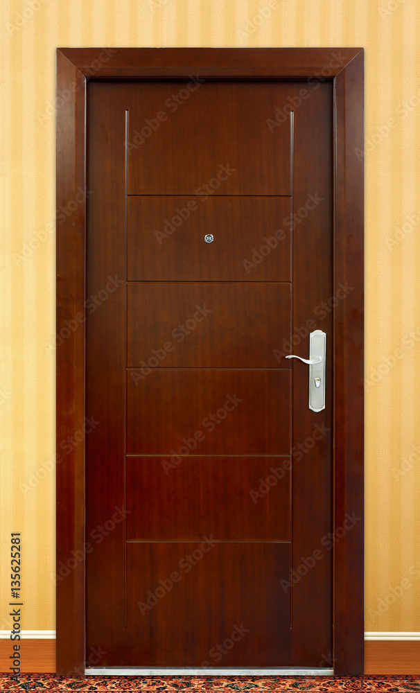 Flat front view of a family home door. Brown color. Yellow color wall.