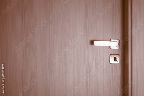 Closed doors wit key in keyhole