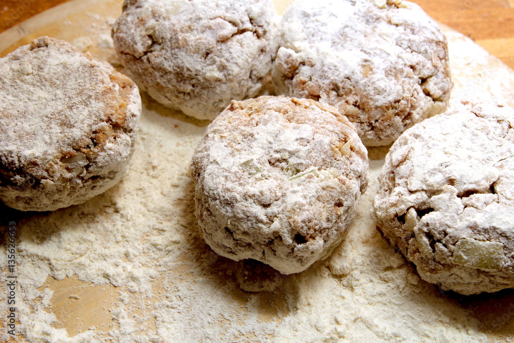 Rissoles, made from minced meat, onion and breadcrumbs, rolled in flour and ready to be fried Rissoles, made from minced meat, onion and breadcrumbs, rolled in flour and ready to be fried