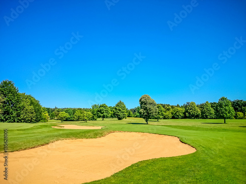 Golf course, natural green meadow, blue sky