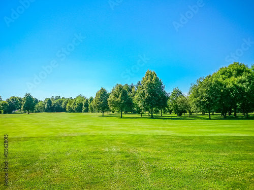 Golf course, natural green meadow, blue sky