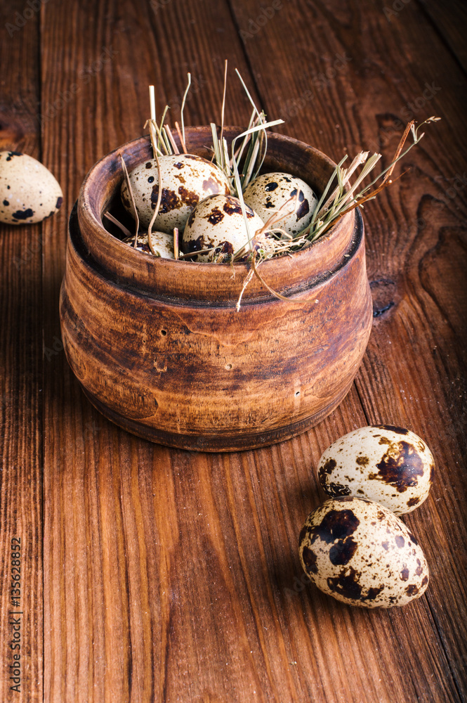 Quail eggs in a wooden bowl on the table Quail eggs in a wooden bowl on the table