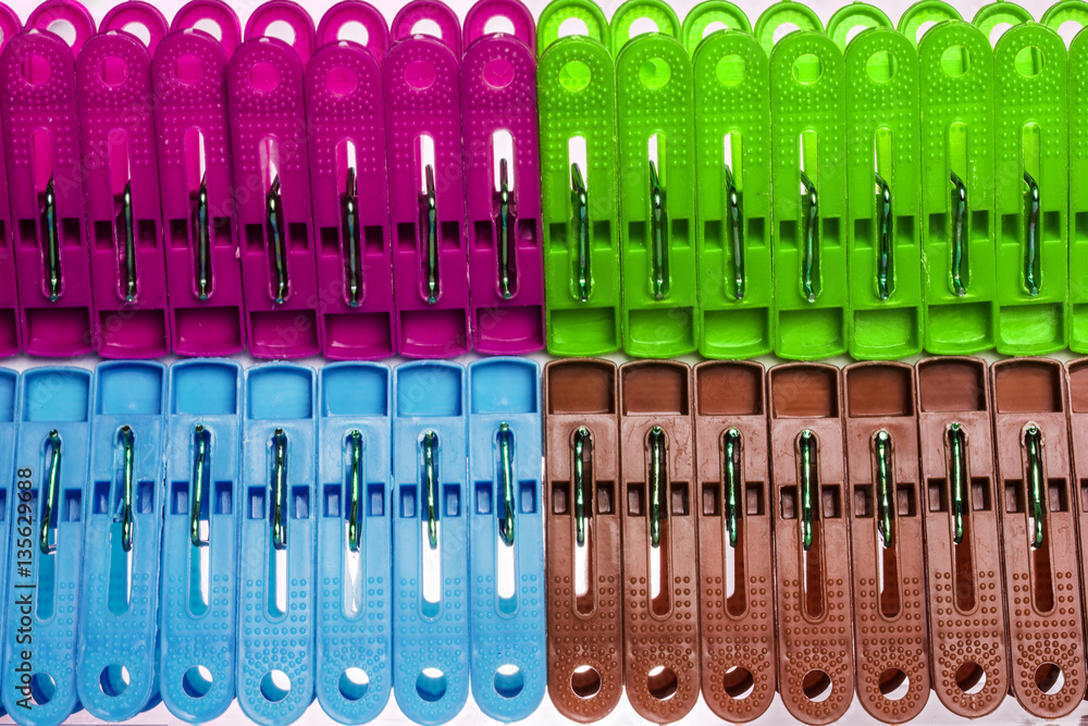 Colorful background of purple, blue, brown, green clothes peg