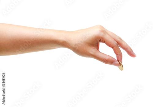Female hand holding a golden coin