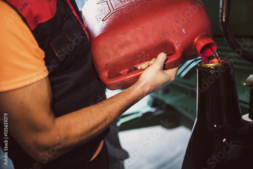 Man puts gas in a vehicle photo