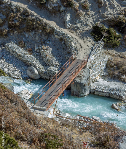The metal bridge on the trail to Everest near Periche village - Nepal, Himalayas photo