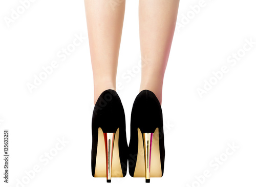 Female legs in black shoes with gold heels, rear view. Elegant sexy woman at a party or date with bare long legs. Beautiful women's ankle isolated on white background