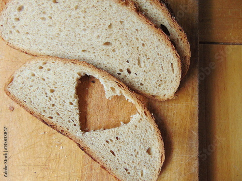 Bread with heart cut out of slice photo