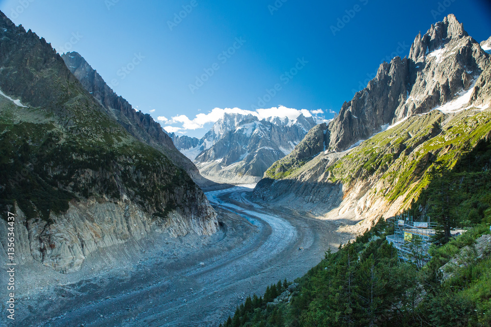 Valley and glacier of Mer de Glace in the French Alps above Chamonix. Train station in foreground.