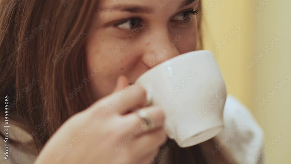 Close-up face of young beautiful schoolgirl, drinking coffee from a cup. Close-up face of young beautiful schoolgirl, drinking coffee from a cup.