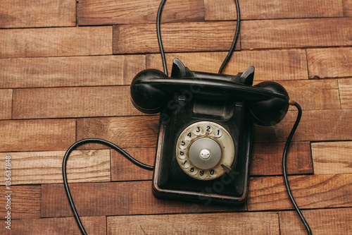 black wired phone on a wooden background