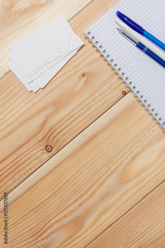 wooden background, notebook and pen